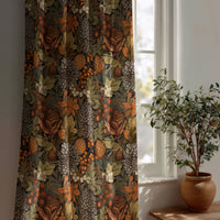 Autumn leaves floral curtain beside a potted olive tree