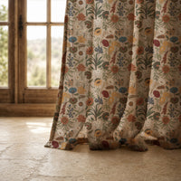 Hem of a autumn wildflower curtain resting on a stone floor