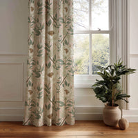 Beige leafy vine botanical curtain panel hanging by a white window