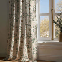 Full-length beige leafy vine botanical curtain draping to a wooden floor