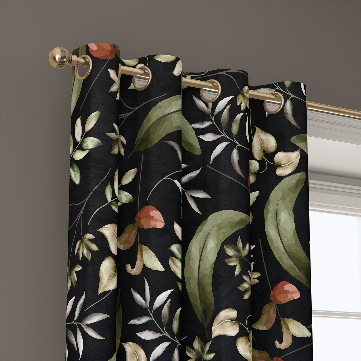 Grommet top of a black botanical floral curtain on a brass rod