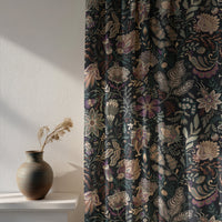 Soft daylight through a black moody floral curtain