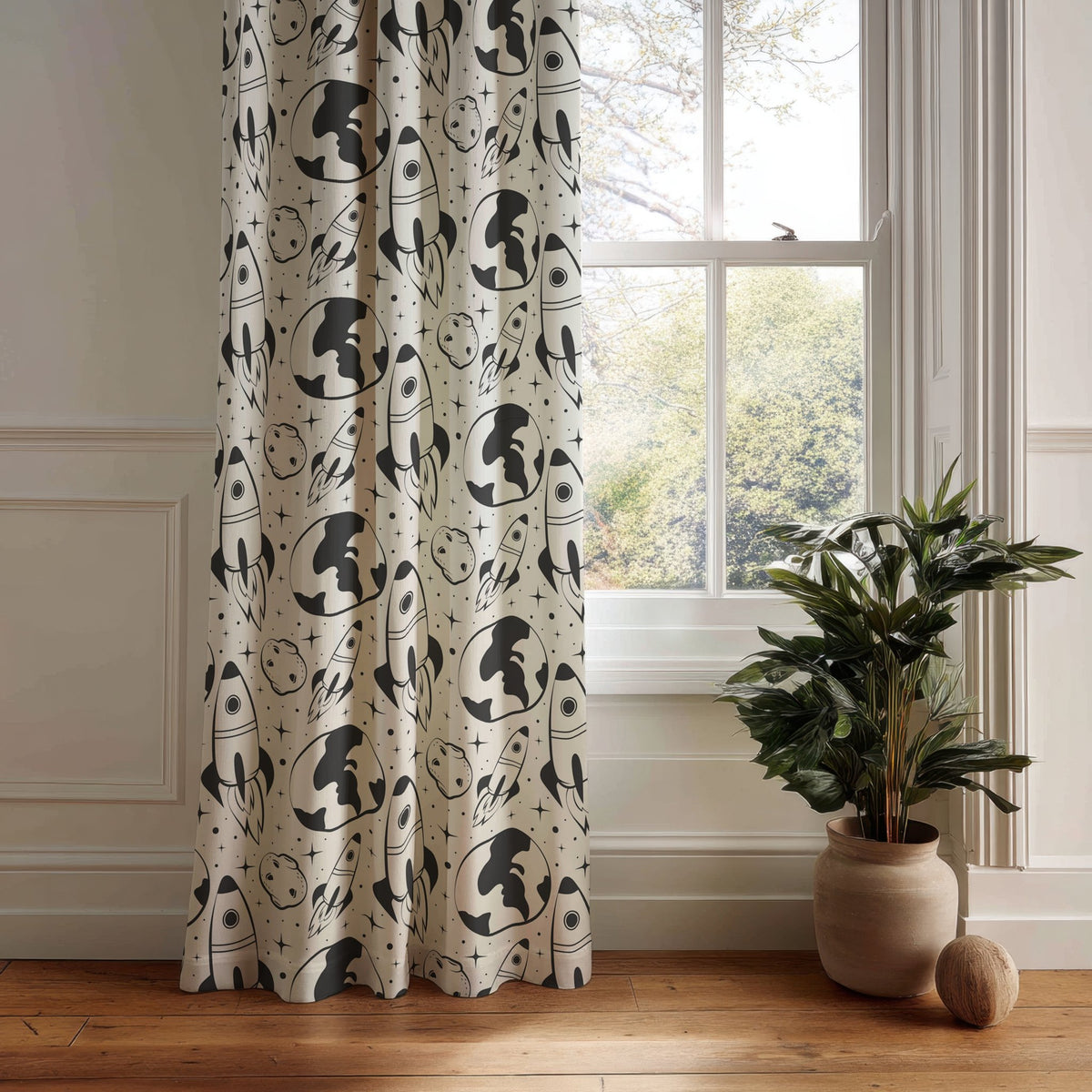 Black and white space rocket kids curtain panel hanging by a white window