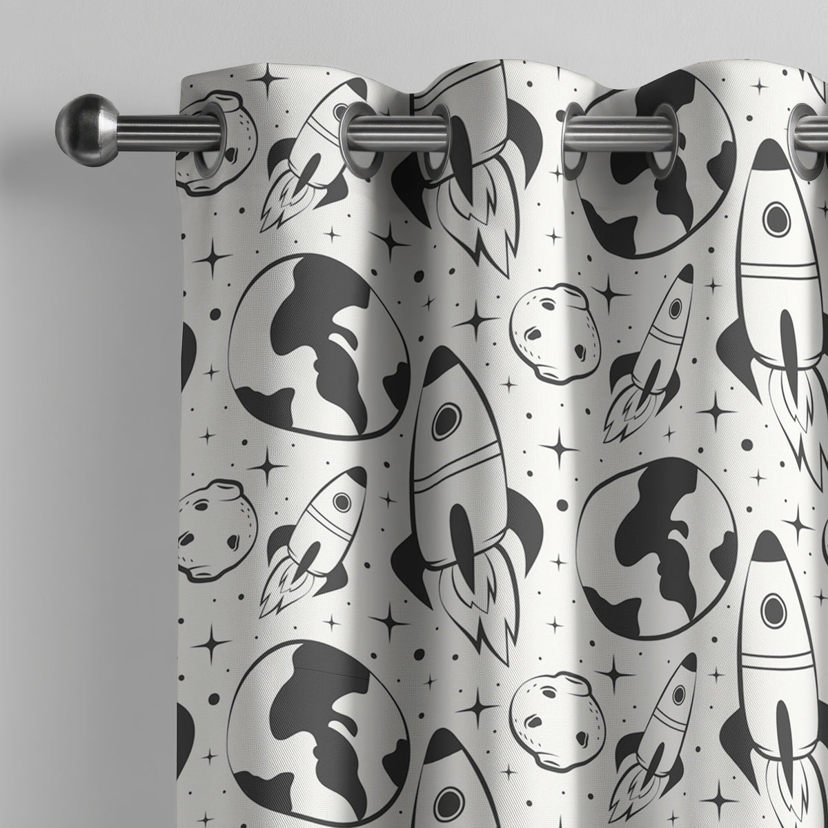 Black and white space rocket kids curtain on a grommet rod, close-up of the print