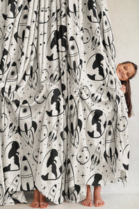 Pair of black and white space rocket kids curtains in a child's bedroom