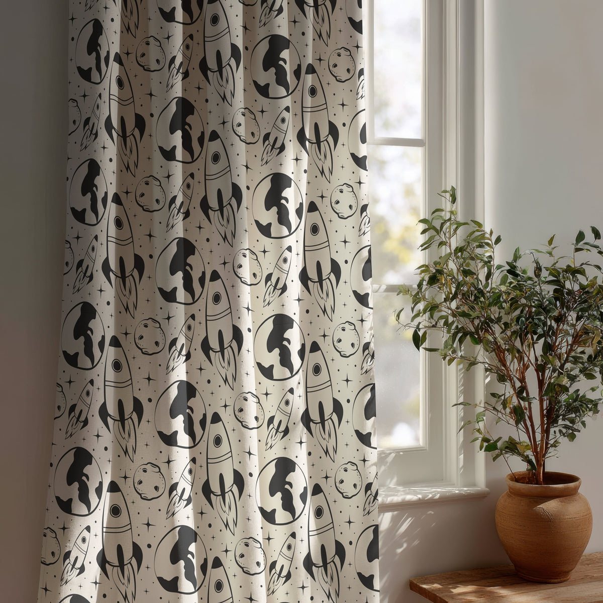 Black and white space rocket kids curtain beside a potted olive tree