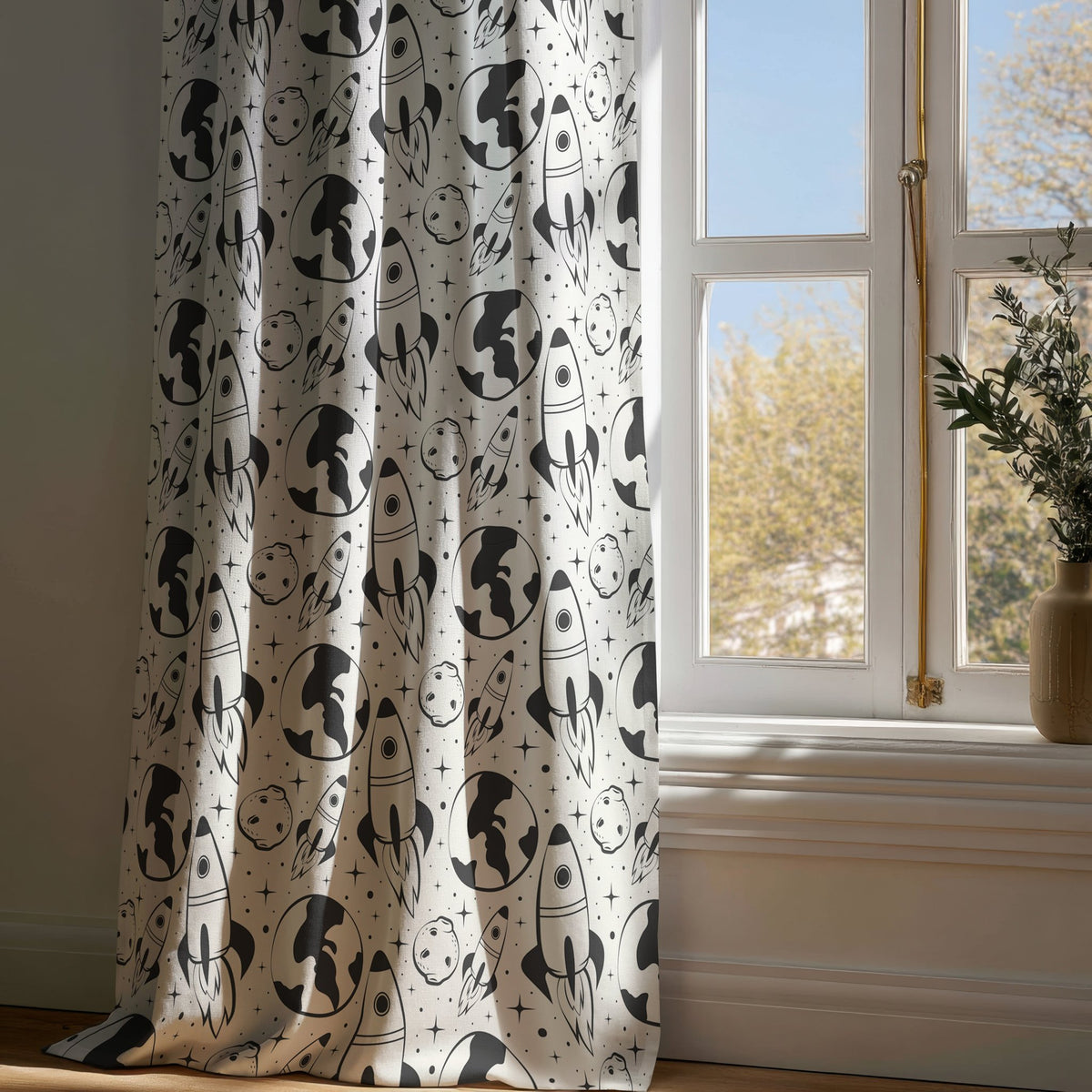 Full-length black and white space rocket kids curtain draping to a wooden floor