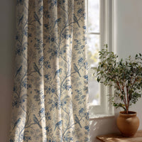 Blue bird chinoiserie curtain beside a potted olive tree