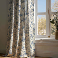Full-length blue bird chinoiserie curtain draping to a wooden floor