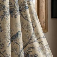 Blue bird toile curtain panel beside a rustic wooden window