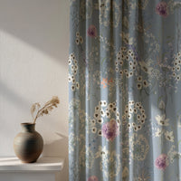 Soft daylight through a blue wildflower print curtain