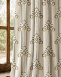 Pair of blue and gold ornamental stripe curtains at an arched window