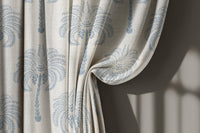 Blue palm tree curtain gathered to one side