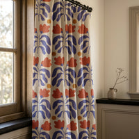 Blue and red cut out leaf curtains in a warm living room