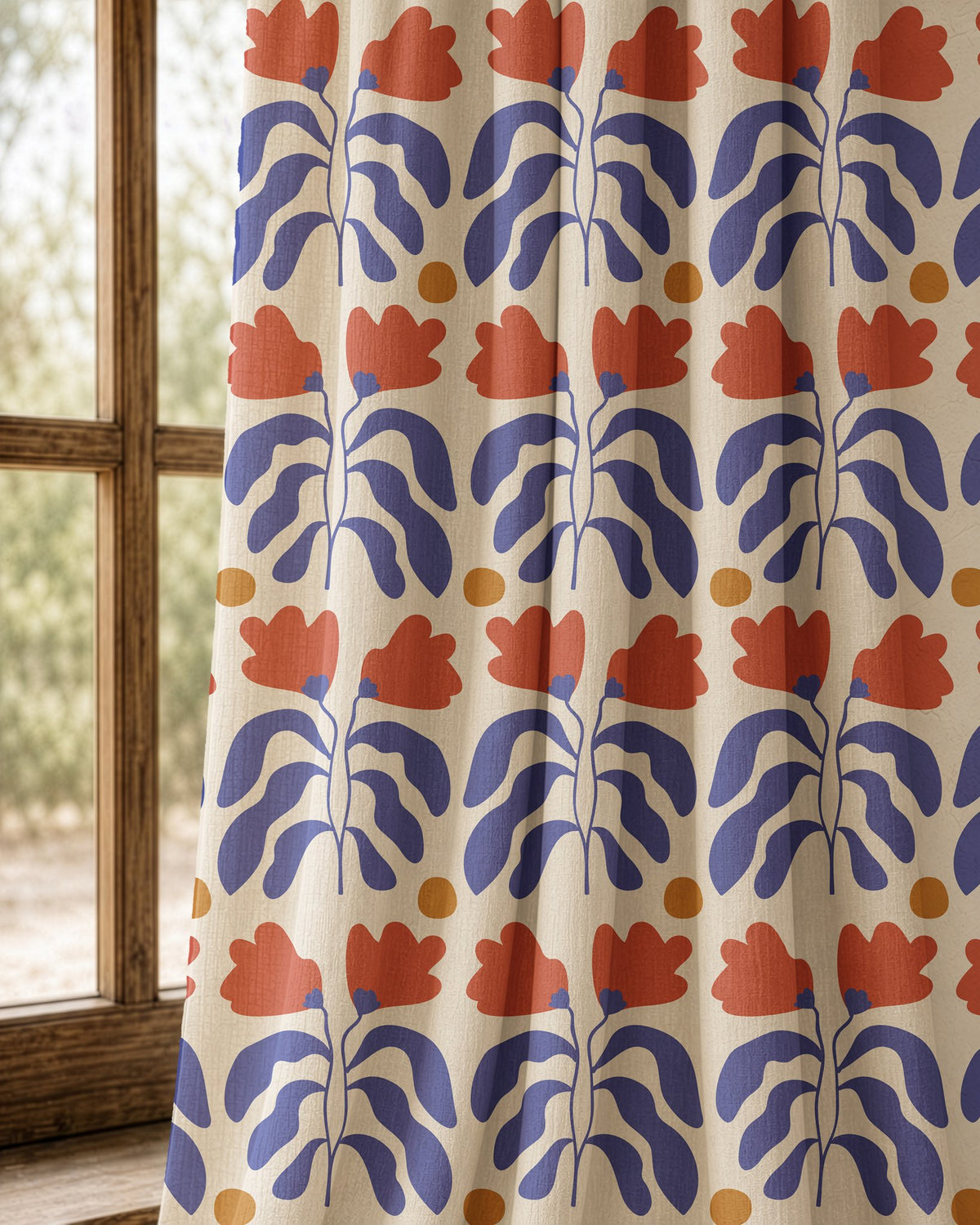 Pair of blue and red cut out leaf curtains at an arched window