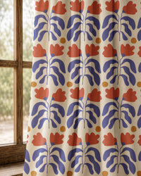 Pair of blue and red cut out leaf curtains at an arched window