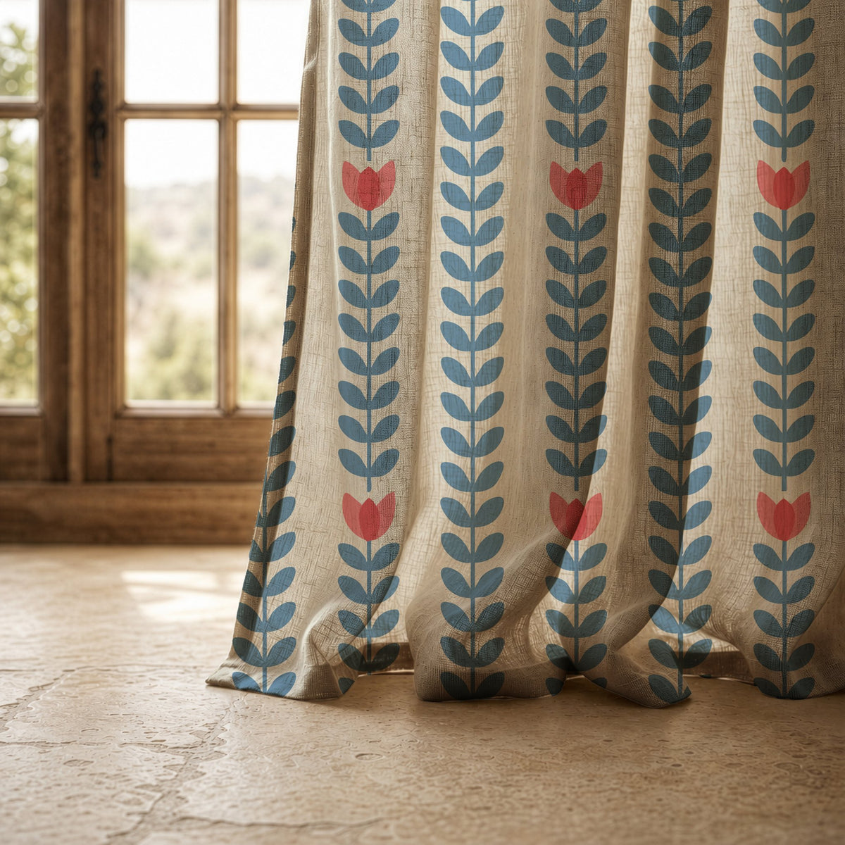 Hem of a blue vine and tulip stripe curtain resting on a stone floor