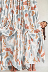 Pair of boho rainbow nursery curtains in a child's bedroom