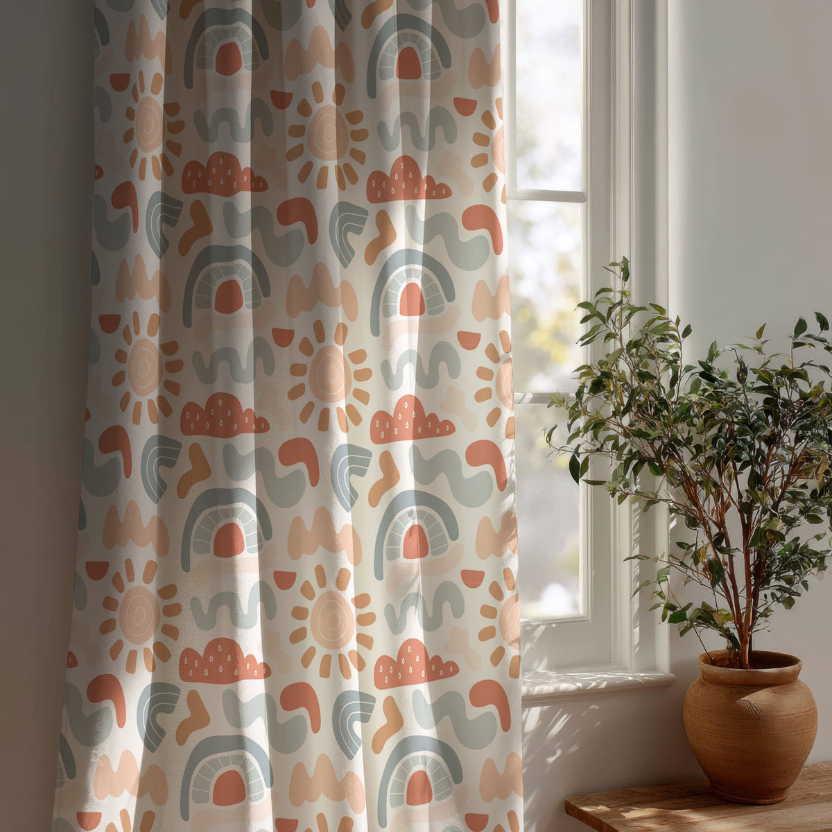 Boho rainbow nursery curtain beside a potted olive tree