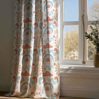 Full-length boho rainbow nursery curtain draping to a wooden floor