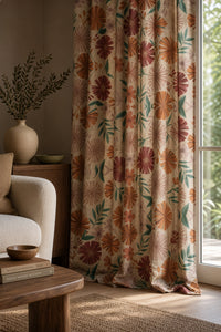 Bold pink and orange floral curtain on a black rod by a window