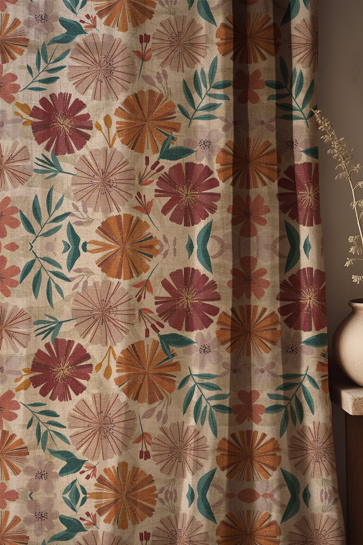 Soft folds of a bold pink and orange floral curtain