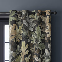 Close-up of charcoal oak leaf curtain grommets on a black rod