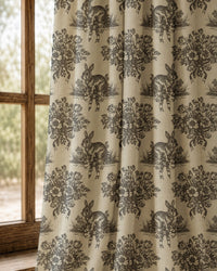 Pair of charcoal rabbit toile curtains at an arched window