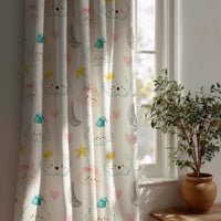 Cloud and moon nursery curtain beside a potted olive tree