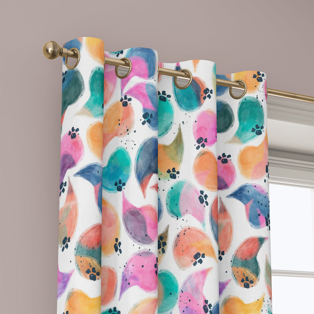 Grommet top of a colorful abstract bird curtain on a brass rod