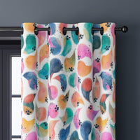 Close-up of colorful abstract bird curtain grommets on a black rod