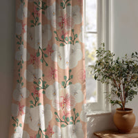 Coral hibiscus floral curtain beside a potted olive tree