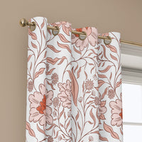 Grommet top of a coral line art blossom curtain on a brass rod