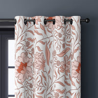 Close-up of coral line art blossom curtain grommets on a black rod