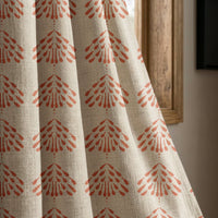 Coral palmette block print curtain panel beside a rustic wooden window