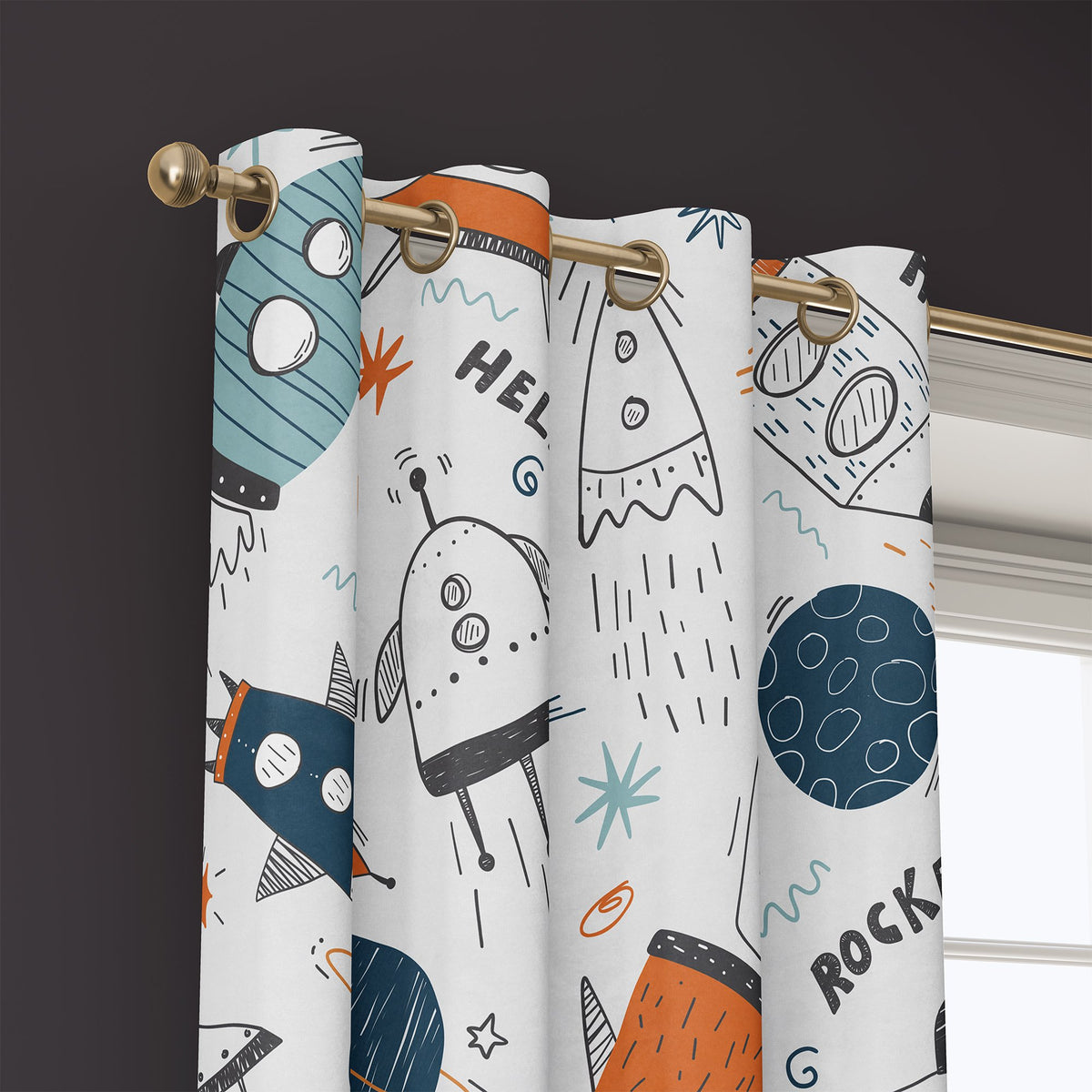 Grommet top of a doodle rocket and ufo kids curtain on a brass rod