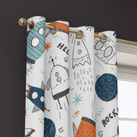 Grommet top of a doodle rocket and ufo kids curtain on a brass rod