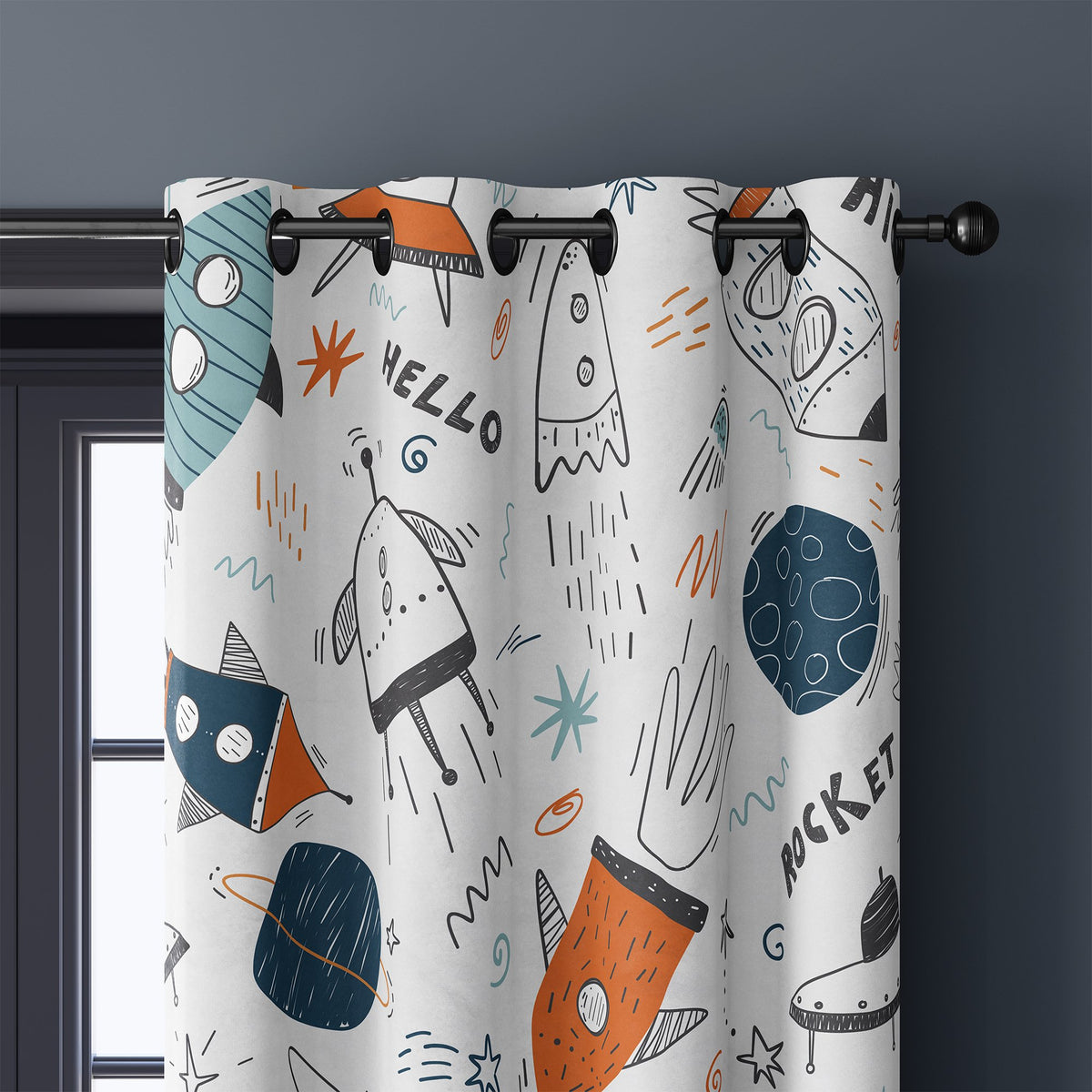 Close-up of doodle rocket and ufo kids curtain grommets on a black rod