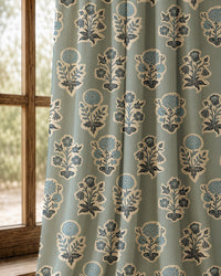 Pair of duck egg blue block print curtains at an arched window
