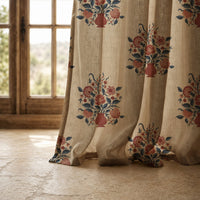 Hem of a flower vase block print curtain resting on a stone floor