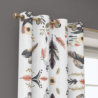 Grommet top of a folk feather print curtain on a brass rod
