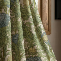Green artichoke and acanthus curtain panel beside a rustic wooden window