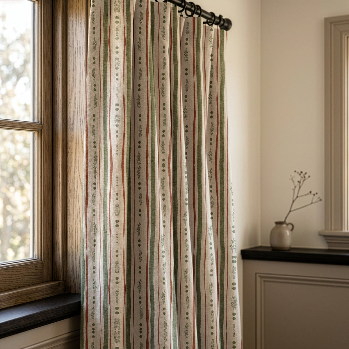 Green and rust painted stripe curtains in a warm living room