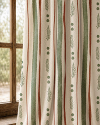 Pair of green and rust painted stripe curtains at an arched window