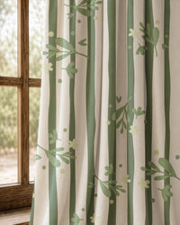 Pair of green stripe botanical sprig curtains at an arched window