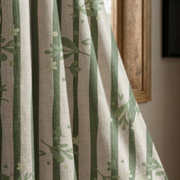 Green stripe botanical sprig curtain panel beside a rustic wooden window