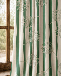 Pair of green stripe dandelion curtains at an arched window