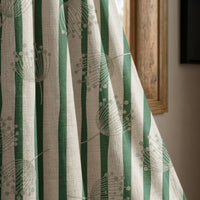 Green stripe dandelion curtain panel beside a rustic wooden window