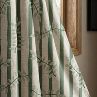 Green stripe leaf vine curtain panel beside a rustic wooden window