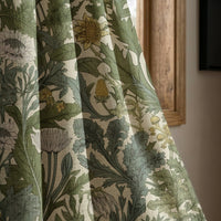 Green thistle botanical curtain panel beside a rustic wooden window